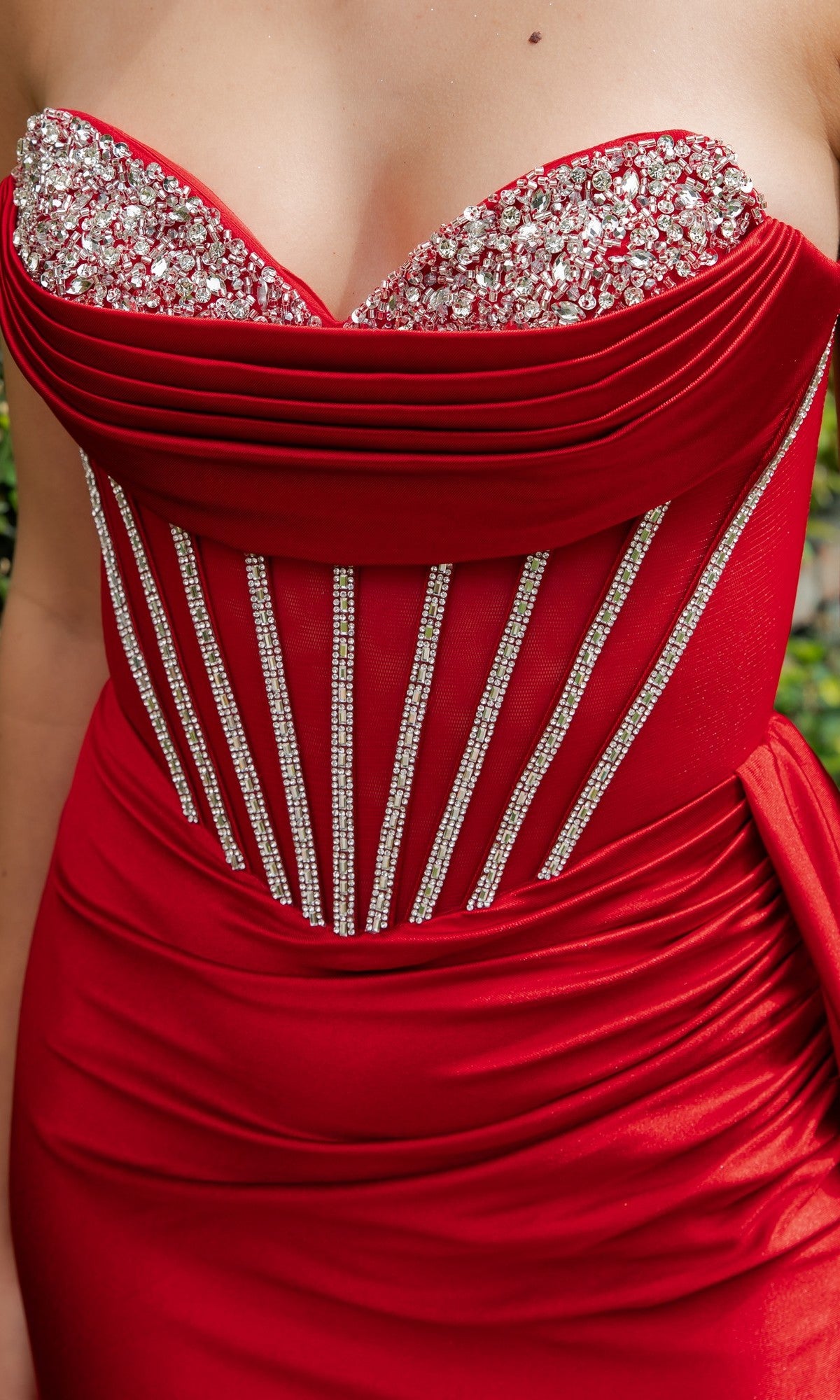 Close-up of a woman in the Cinderella Couture 8454J long prom dress, showcasing a strapless satin design with jeweled bodice embellishments and vertical rhinestone accents.
